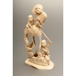 A JAPANESE IVORY FIGURE GROUP, Meiji period, carved as a large crane with two boys playing on its