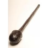 A FIJIAN BULI BULI CLUB with boss carved mushroom head, stepped shaft and geometric carved grip,