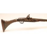 A DOG LEG ACTION MUSKET, possibly North African, with 34" barrel, rear sight, chevron carved stock