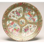 A CANTONESE PORCELAIN DISH of plain circular form, painted in famille rose enamels with four