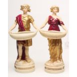 A PAIR OF ART NOUVEAU ROYAL DUX BISQUE PORCELAIN FIGURES, each wearing a toga and drapery in