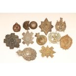 ELEVEN BRITISH MILITARY BADGES comprising eight Scottish regimental cap badges, two Welsh and one