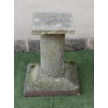 A SANDSTONE WALL SUNDIAL, dated 1711, (lacking gnomen), 18" x 17", now mounted on a cylindrical