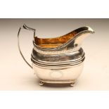 A GEORGE III SILVER MILK jug, maker Duncan Urquhart & Naphtali Hart, London 1810, of rounded