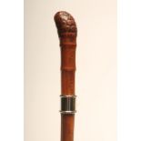 A BAMBOO SWORD STICK, early 20th century, with 29 1/4" square section tapering blade, white metal