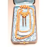 A VICTORIAN CORAL SUITE comprising a 24 1/2" long single string of graduated beads, crescent