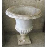 A WHITE MARBLE CAMPANA URN, on associated stoneware base, 25" wide, 30" high