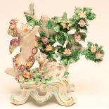 A BOW PORCELAIN FIGURAL CANDLESTICK BASE, c.1760, modelled as a flower garlanded putti balancing