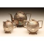 AN EASTERN WHITE METAL THREE PIECE TEA SERVICE, late 19th century, unmarked, of globular form, all