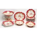 AN ENGLISH PORCELAIN DESSERT SERVICE, c.1830, of shaped circular form with escallop shell and scroll