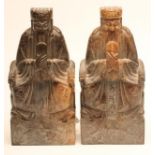 A PAIR OF CHINESE SOAPSTONE FIGURES carved as bearded dignitaries seated on a throne and holding a