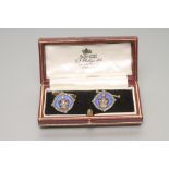 A PAIR OF CUFFLINKS, with a crown motif, overlaid in blue guilloche enamel set with a border of rose