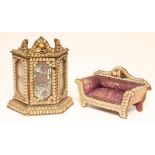 A Victorian doll's house side cabinet and settee, 1873, the glazed and mirrored canted oblong