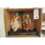 A pair of Japanese costume dolls, with painted cut out features, elaborate blonde wigs, both wearing