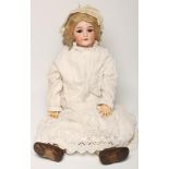 A Schoenau Hoffmeister bisque head doll with brown glass sleeping eyes, open mouth and teeth, blonde