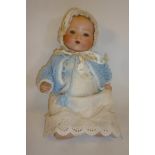 An Armand Marseille bisque head baby doll with blue glass sleeping eyes, open mouth and teeth,