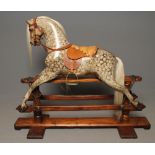 A rocking horse, early 20th century, but later extensively restored, in carved dapple painted