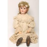 A large K & R Simon & Halbig bisque head doll, with brown glass sleeping eyes, open mouth and teeth,