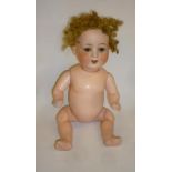 An Armand Marseille bisque head doll with brown glass sleeping eyes, open mouth and teeth, fair