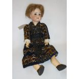 An Armand Marseille Flora Dora bisque head doll with brown glass sleeping eyes, open mouth and