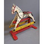 A painted wood rocking horse, mid 20th century, made of two dimensional elements, with leather