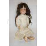 An Armand Marseille bisque head doll with fixed brown glass eyes, open mouth and teeth, brown mohair