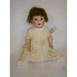 A Schoenau & Hoffmeister bisque head character doll with brown glass sleeping eyes, open mouth and