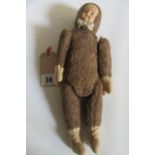 An Eskimo doll, pre-war, possibly Steiff, with inset celluloid moulded face with painted features,