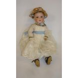 An Armand Marseille bisque head doll with fixed blue glass eyes, open mouth and teeth, light brown