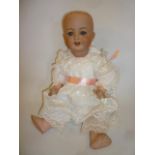 An Armand Marseille bisque head doll with blue glass sleeping eyes, open mouth and teeth, no wig,