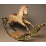 A rocking horse, late 19th century, in painted and carved wood with head to one side,