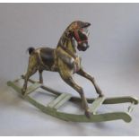 A rocking horse in painted wood, mid 20th century, with carved harness, horse hair tail, on