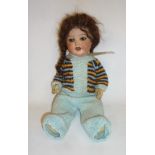 An Ernst Heubach bisque head character doll with brown glass sleeping eyes, open mouth, trembling
