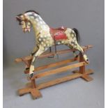 A rocking horse, possibly Lines Bros, mid 20th century, in dappled painted carved wood with