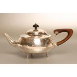 AN ARTS AND CRAFTS SILVER TEAPOT, maker Charles Edwards, London 1920, of squat globular form with