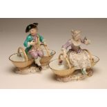 A PAIR OF MEISSEN PORCELAIN FIGURAL SWEETMEATS, late 19th century, modelled as a boy wearing a black