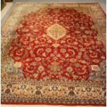 A PERSIAN MAHAL CARPET, the scarlet field with ivory and lime green gul on a floral ground with