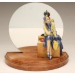 AN ART DECO GERMAN EARTHENWARE FIGURE, modelled as a stylish young lady wearing a yellow and blue