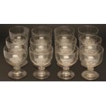 A GEORGIAN SET OF TWELVE GLASS GOBLETS, early 19th century, the large circular bowls on a basal