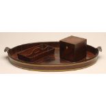 A GEORGIAN MAHOGANY AND BRASS BOUND TEA TRAY, 18th century, of oval form, with scrolled handles,