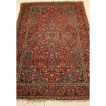 A PERSIAN RUG, the marine blue field with large red gul centred by a small ivory gul, all over