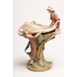 AN ART NOUVEAU ROYAL DUX BISQUE PORCELAIN FIGURAL CENTREPIECE, modelled as two maidens overlooking a