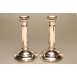 A PAIR OF SILVER CANDLESTICKS, maker's mark rubbed, Birmingham 1945, with fixed sloping drip pans,