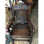 Large Edwardian oak chair with carved panel back