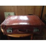 Good quality crocodile skin suitcase fitted with silver mounted toiletry bottles etc.