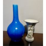 Two pottery vases one blue ground and one painted with flowers