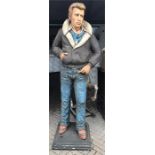 Life size figure of James Dean wearing jeans and flying jacket. Made of fibreglass on stand, approx