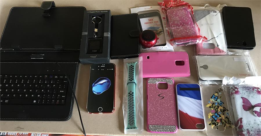 A large quantity of phone cases to include a tablet keyboard and digital photo keychain