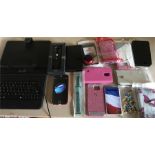 A large quantity of phone cases to include a tablet keyboard and digital photo keychain