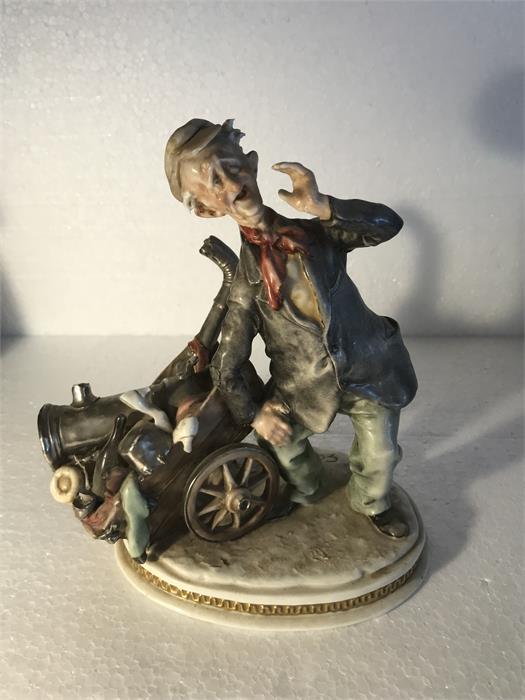 A Capodimonte figure of a man with barrow - 18cm h